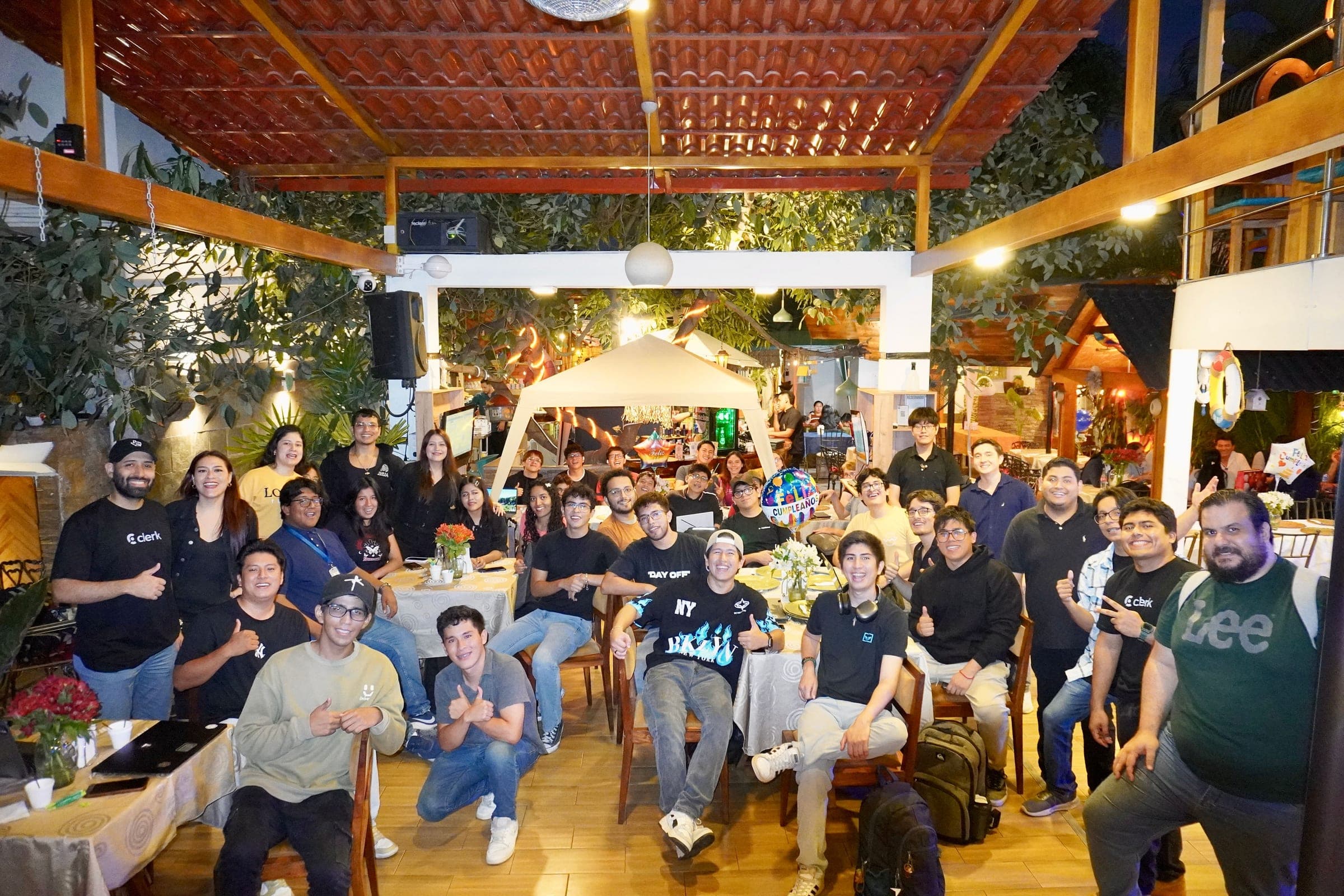 Meetup attendees gathered on a lantern-lit patio