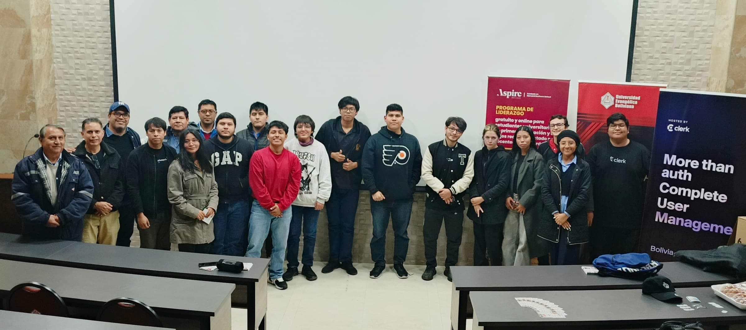 Group photo in a lecture room with Clerk banners