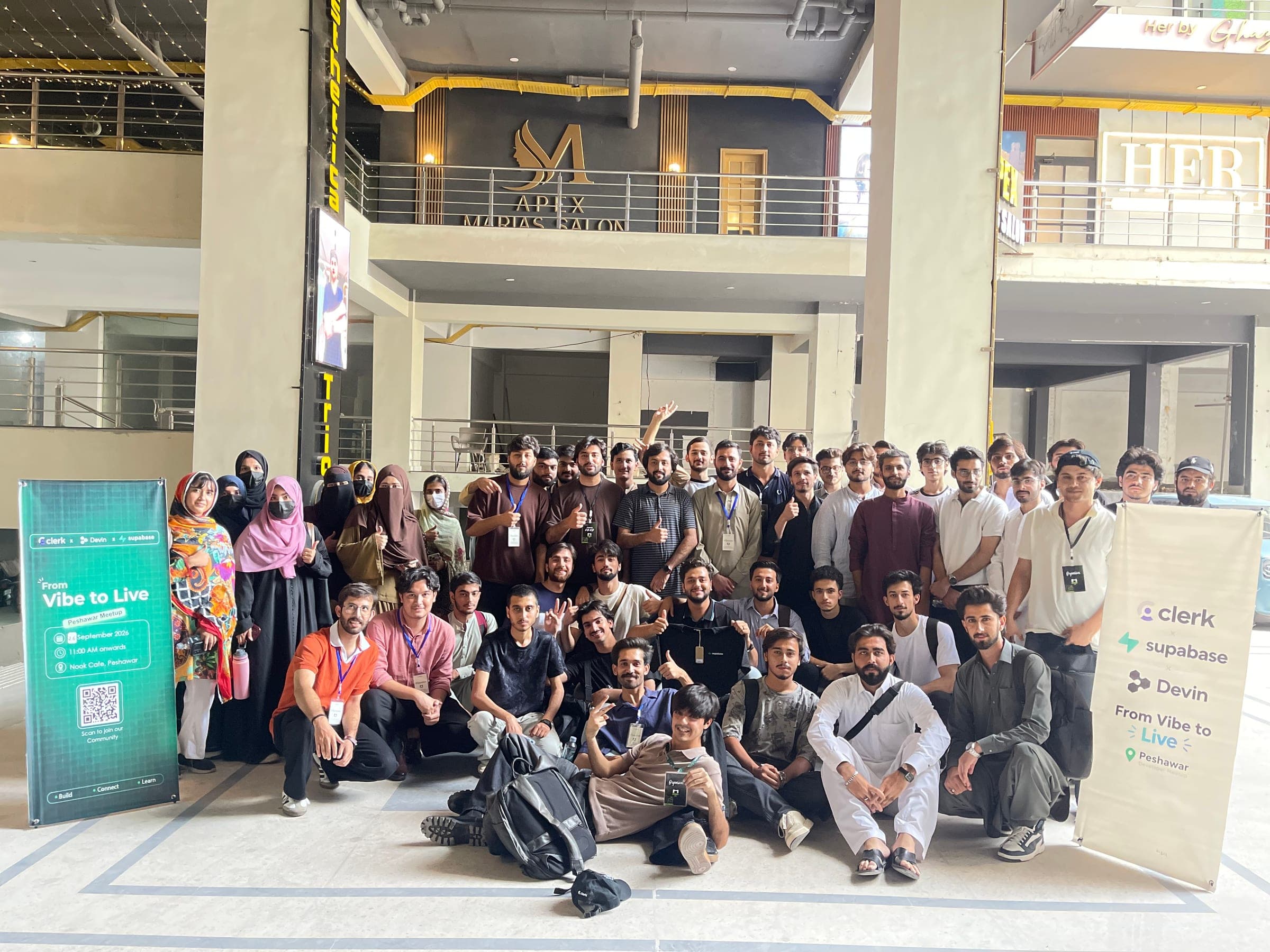 Group photo in a courtyard beside Clerk banners