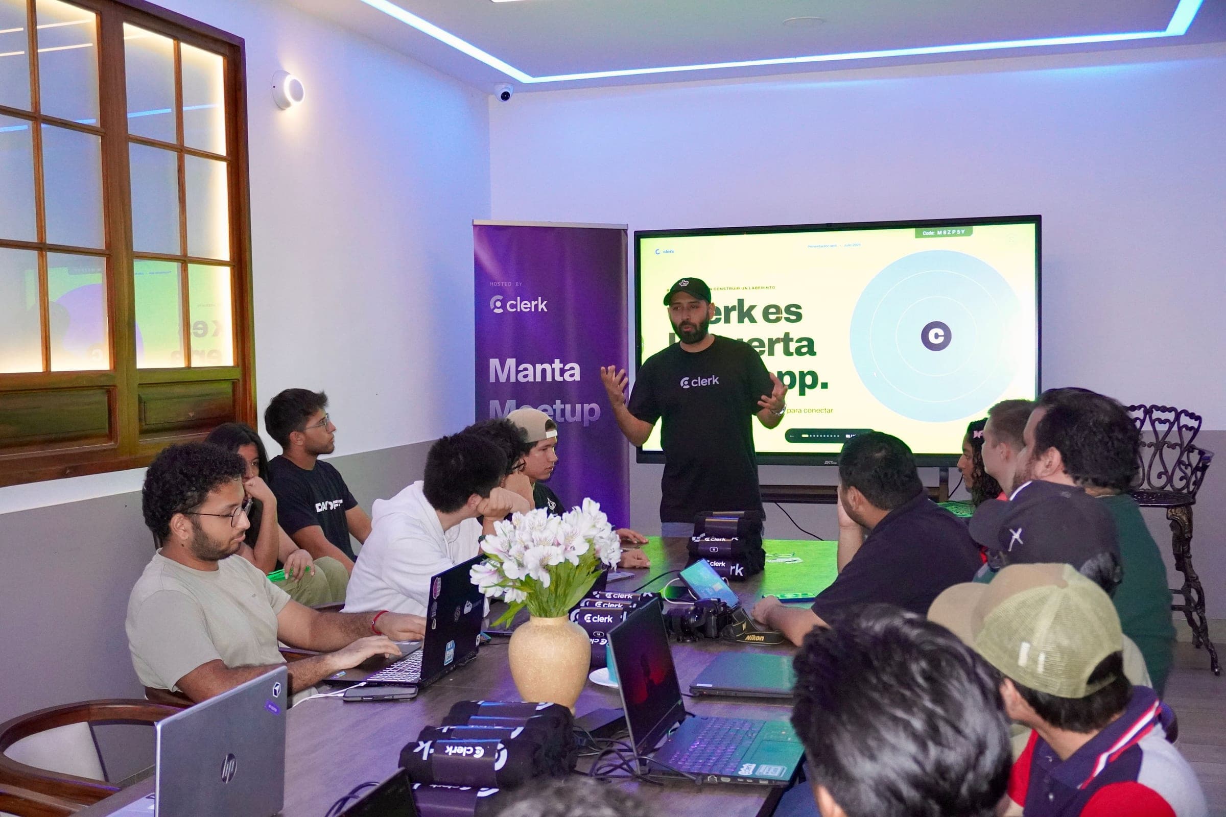Speaker presenting to developers at a Clerk meetup