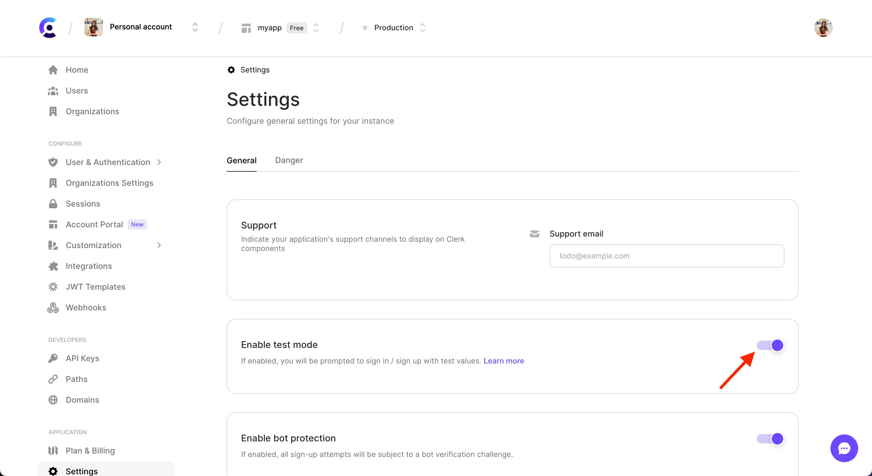 The 'Enable test mode' section of the Settings page in the Clerk Dashboard. There is a red arrow pointing to the toggled, which is toggled on